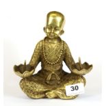 A Chinese gilt bronze figural candle holder, H. 17cm.