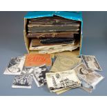 A box of mixed old photographs, cigarette cards and ephemera.