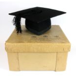 A boxed Ede and Ravenscroft mortarboard.