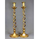 A pair of early 20th Century brass open barley twist candlesticks, H. 49cm.