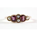 An antique 9ct rose gold (stamped 9ct) ring set with seed pearls and tourmalines in an old ring box,