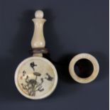 A Chinese carved and engraved bone snuff bottle with carrying handle, H. 7.5cm.