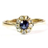 An antique 9ct yellow gold cluster ring set with an old cut sapphire and rose cut diamonds, (R.5).