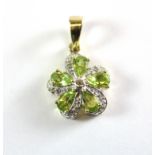 A 9ct yellow gold peridot and diamond set flower shaped pendant.