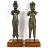 A pair of Khmer style bronze sculptures on wooden plinths, H. 50cm.