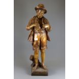 A large 19th Century Austrian painted terracotta figure of a boy holding a small fish, H. 74cm.