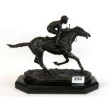 A bronze figure of a jockey and racehorse on a wooden plinth, H. 22cm.