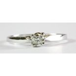 A 9ct white gold diamond set solitaire ring, (J).