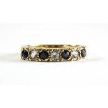 A 9ct yellow gold sapphire and white stone set half eternity ring, (N).