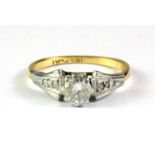 An 18ct gold and platinum diamond set solitaire ring, (J).