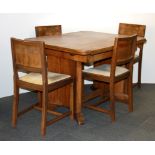 An Art Deco draw leaf table and four chairs.