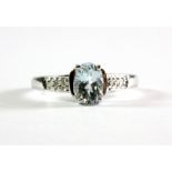 A 9ct white gold aquamarine set ring with diamond set shoulders, (L.5).