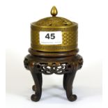 A Chinese gilt bronze censer on a carved wooden stand, overall H. 15cm.