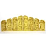 A small carved yellow wood eight panel screen of Buddhist deities, W. 39cm, H. 14cm.