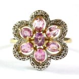 A 9ct yellow gold pink sapphire and diamond set flower shaped ring, (O).