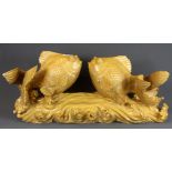 An Oriental carved sculpture depicting two fishes riding the waves, 60 x 26 x 22cm.