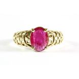 A 9ct yellow gold ring set with a 1.3ct oval cut ruby, (P.5).