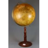 A mid-20th Century Globe on a turned wood stand, H. 65cm.