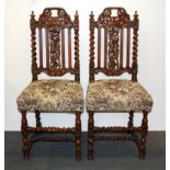 A pair of 19th Century carved oak hall chairs.