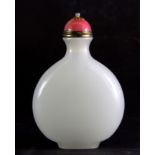 A Chinese white glass snuff bottle simulating white jade with a gilt and pink hardstone stopper,