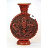 A Chinese cinnabar lacquered vase decorated with dragons, H. 26cm.