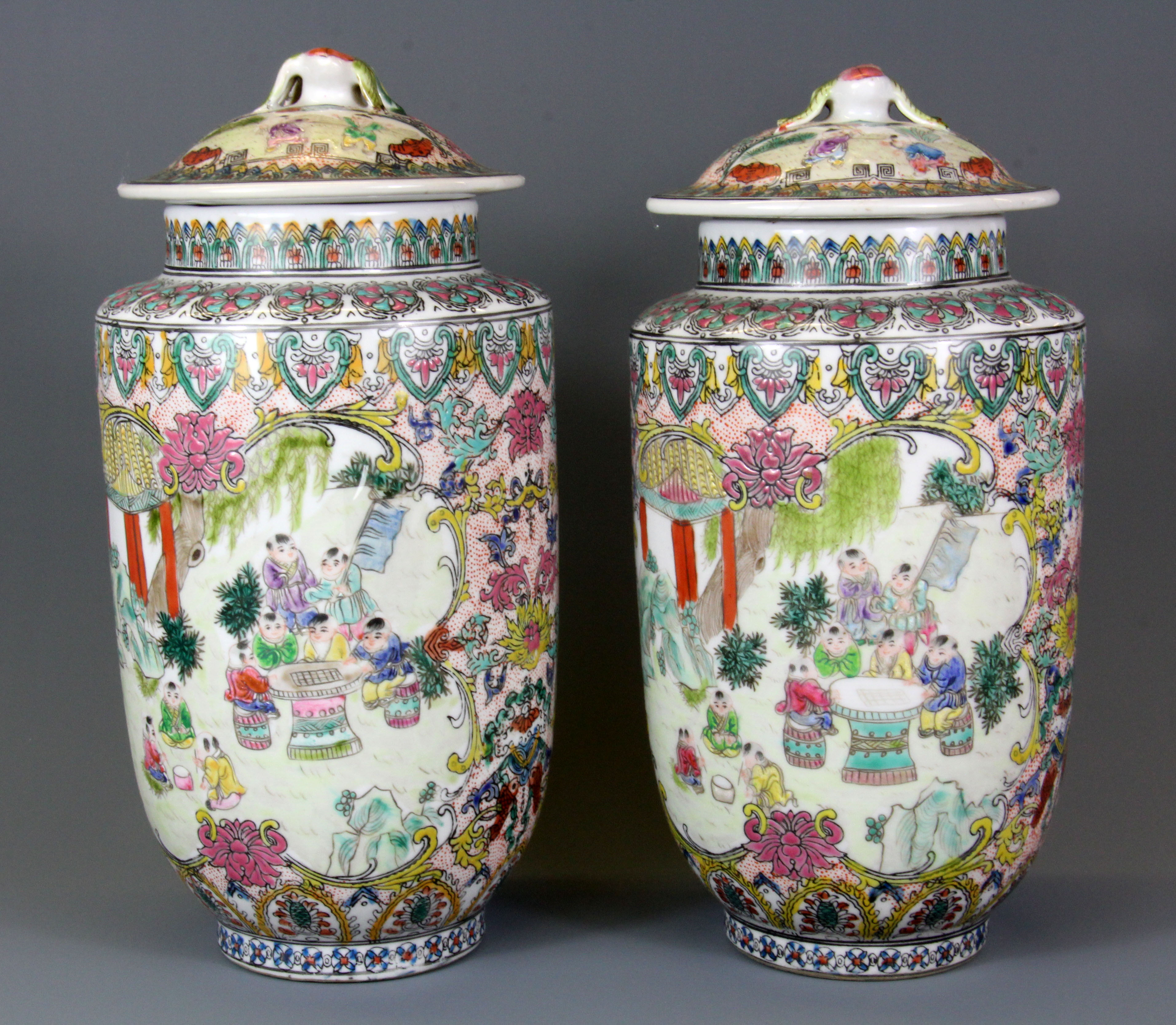 A pair of mid-20th Century Chinese hand enamelled porcelain jars and lids, H. 25cm.