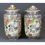 A pair of mid-20th Century Chinese hand enamelled porcelain jars and lids, H. 25cm.