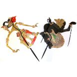 Two Indonesian painted pig skin shadow puppets with horn support handles, tallest 72cm.