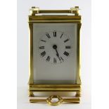 A good quality brass carriage clock with presentation date 1922 and crowned monogram M, H. 14cm.