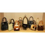 A collection of Vincenza glass handbags and one other glassware.