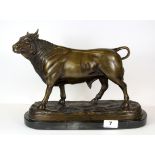 A large bronze model of a bull on a black and grey marble base, H. 26cm, L. 36cm.