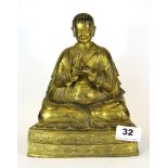 A Tibetan gilt bronze figure of a seated deity (probably 19th Century), H. 21cm.