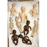 A group of porcelain articulated and half dolls, H. 9cm.