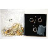 A bag of costume jewellery with a boxed necklace.