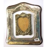 A large 925 silver photo frame, 35 x 30cm, together with an ornate pressed photo frame.