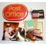 An old Post Office sign, postal order tray and a group of post office realted photographs.