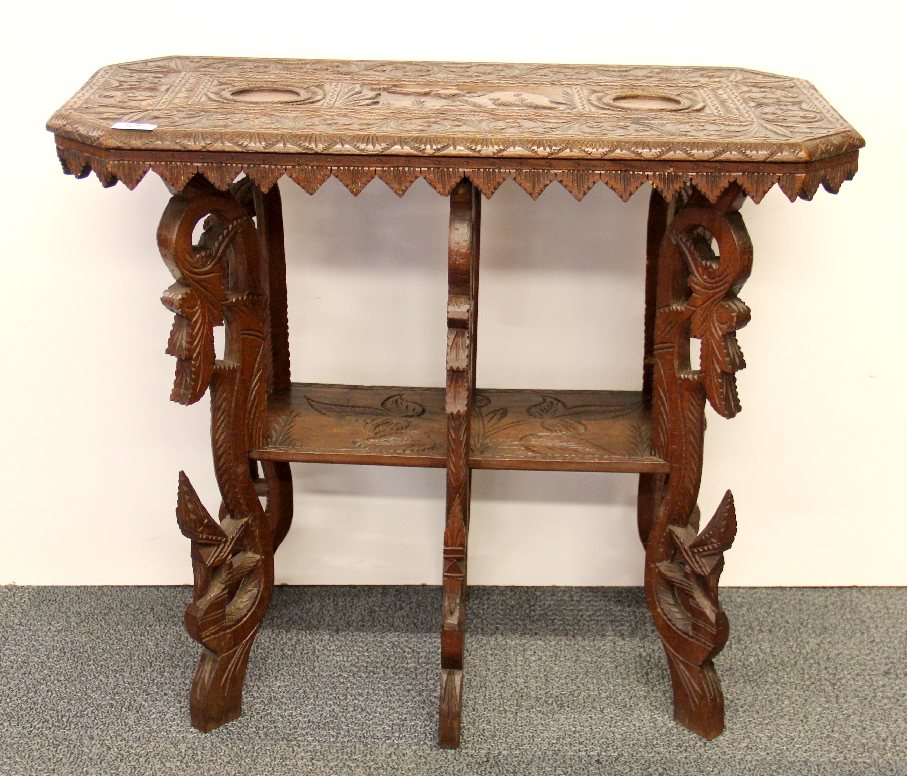 A Burmese carved hardwood table, 77 x 38 x 66cm.