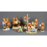 A group of Hummel child figurines.