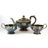 A hallmarked silver three piece tea set, tea pot 15cm.