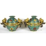 A pair of Chinese cloisonné enamelled gilt bronze jars with flying fish handles, H. 16cm.