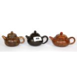 Three small Chinese terracotta teapots, H. 7cm.