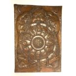 A Tibetan hammered copper mandala of the year signs protected by a fierce guardian, 23 x 32cm.