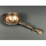 An early 20th Century Chinese hallmarked silver tea strainer, L. 16.5cm.