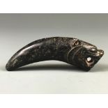 An early Chinese carved nephrite jade tiger tooth protective amulet, L. 10cm.