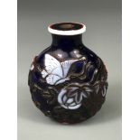 A mid 20th Century Chinese three colour carved Peking cameo glass snuff bottle decorated with