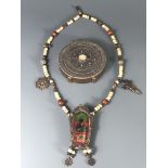 A Tibetan painted and carved bone prayer necklace mounted with bronze sacred symbols, together