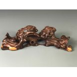 A Chinese carved hardwood natural form brush rest, W. 20cm.