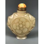 A Chinese carved nephrite jade snuff bottle, H. 5cm, with a later gilt and coral stopper.