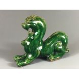 A Chinese green glazed marbled clay figure of a dragon, H. 17cm, (A/F to right ear).