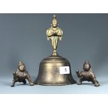 A 19th Century Nepalese bronze temple bell, H. 21cm, together with two small bronze deity figures.